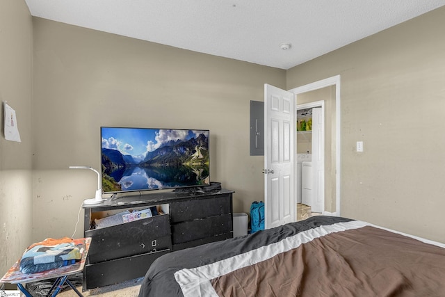 bedroom featuring washer / clothes dryer and electric panel