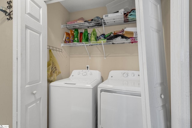 clothes washing area with washing machine and clothes dryer