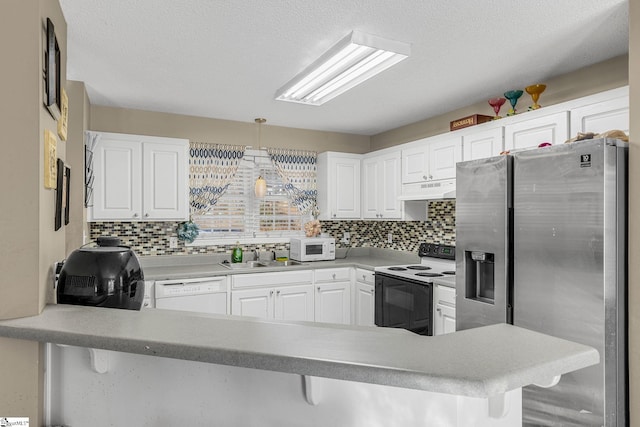 kitchen with white cabinetry, white appliances, kitchen peninsula, and hanging light fixtures