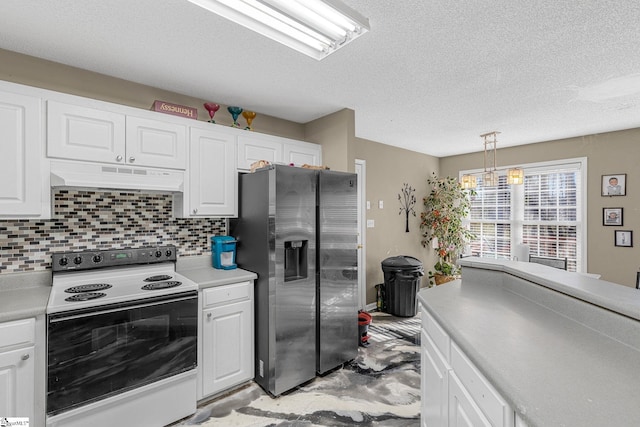 kitchen featuring range with electric stovetop, stainless steel fridge, decorative light fixtures, and white cabinets