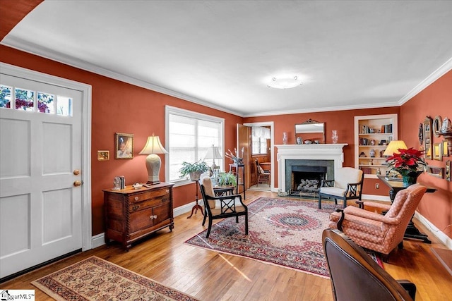 living room featuring light hardwood / wood-style flooring and ornamental molding