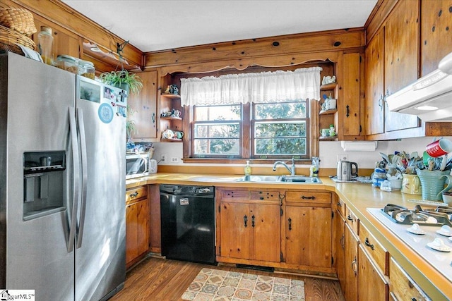 kitchen featuring sink, light hardwood / wood-style flooring, dishwasher, stainless steel refrigerator with ice dispenser, and white gas cooktop