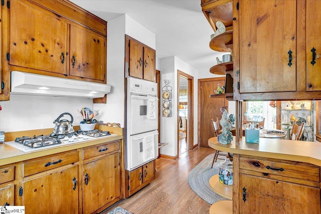 kitchen featuring white appliances and light hardwood / wood-style floors