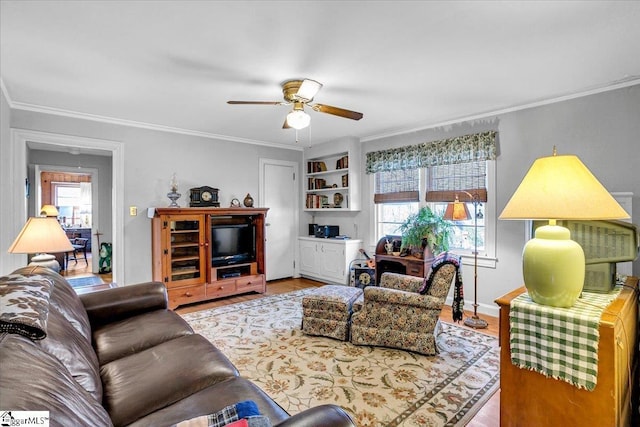 living room with crown molding, plenty of natural light, ceiling fan, and light hardwood / wood-style floors