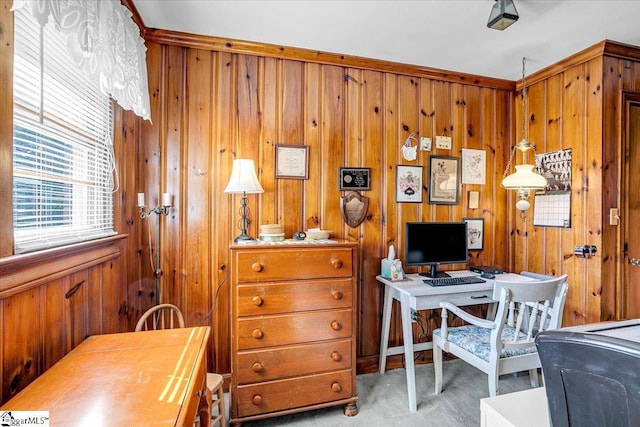 home office with wooden walls and light carpet