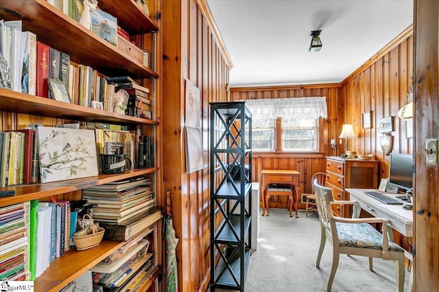 office area featuring light carpet and wood walls