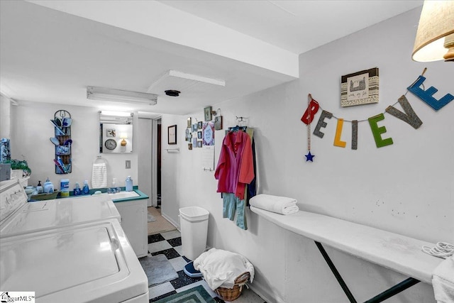 bathroom with washing machine and clothes dryer