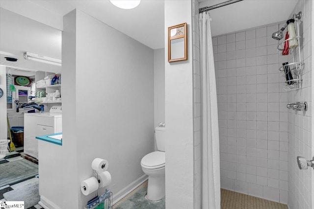 bathroom featuring washer / clothes dryer, toilet, and a shower with curtain