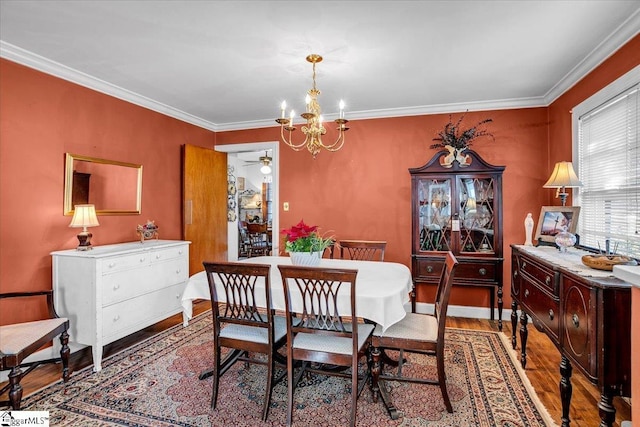 dining space featuring an inviting chandelier, hardwood / wood-style floors, and ornamental molding