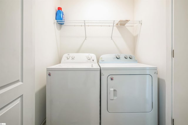 clothes washing area with independent washer and dryer