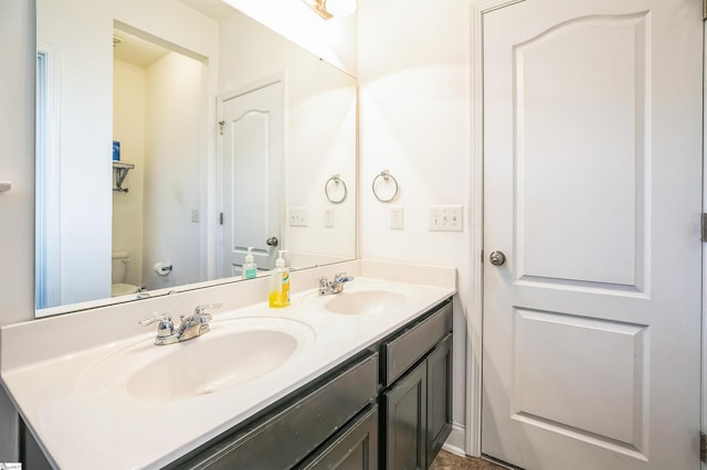 bathroom featuring vanity and toilet