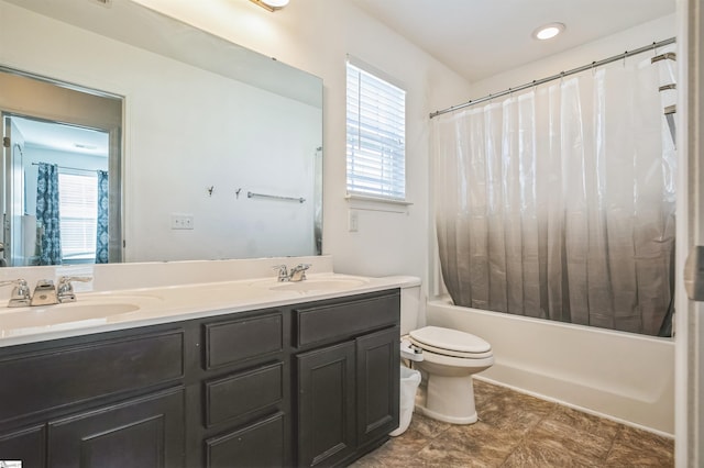 full bathroom with vanity, plenty of natural light, shower / bathtub combination with curtain, and toilet