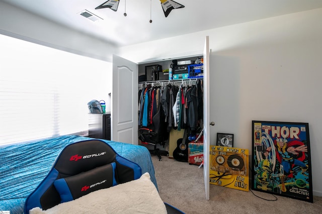 carpeted bedroom featuring a closet and ceiling fan