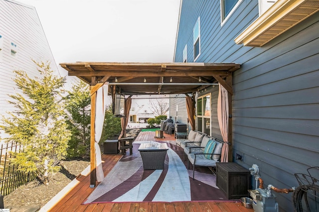 view of patio with an outdoor living space with a fire pit and a deck