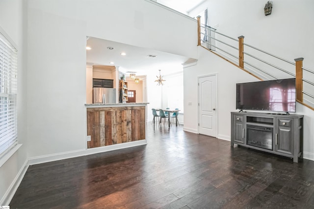 unfurnished living room with dark hardwood / wood-style flooring