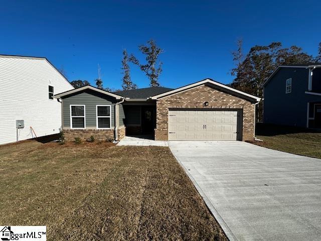 view of front of property with a garage and a front yard