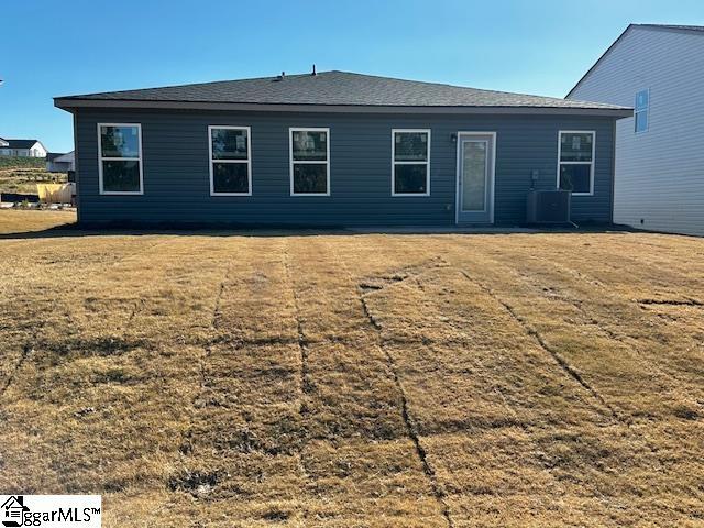 back of house featuring cooling unit and a yard