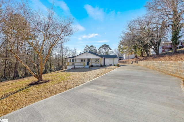 ranch-style house with a front lawn and a porch