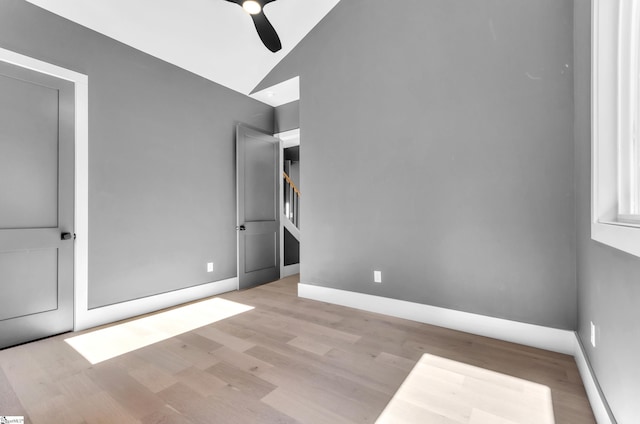 unfurnished bedroom with lofted ceiling, ceiling fan, and light hardwood / wood-style flooring