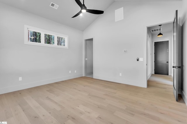 empty room featuring ceiling fan, high vaulted ceiling, and light hardwood / wood-style flooring