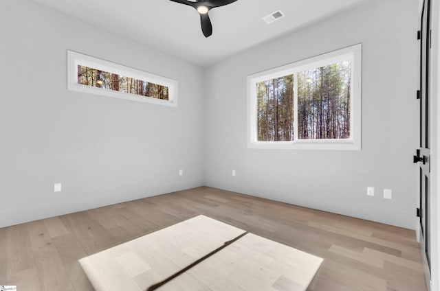 empty room featuring ceiling fan and light hardwood / wood-style floors