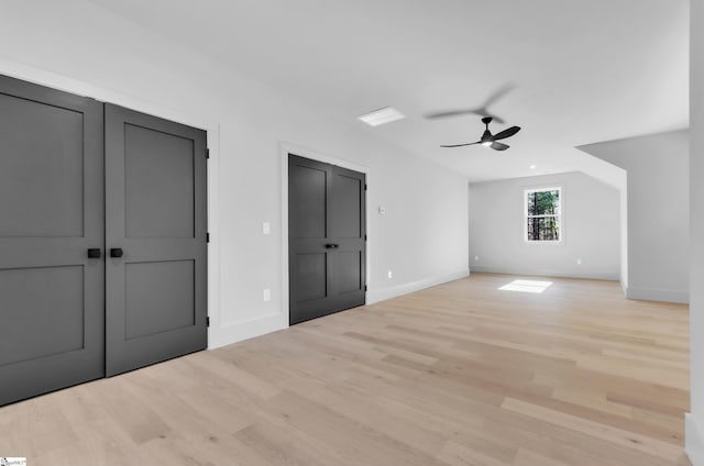 unfurnished bedroom with ceiling fan and light hardwood / wood-style floors