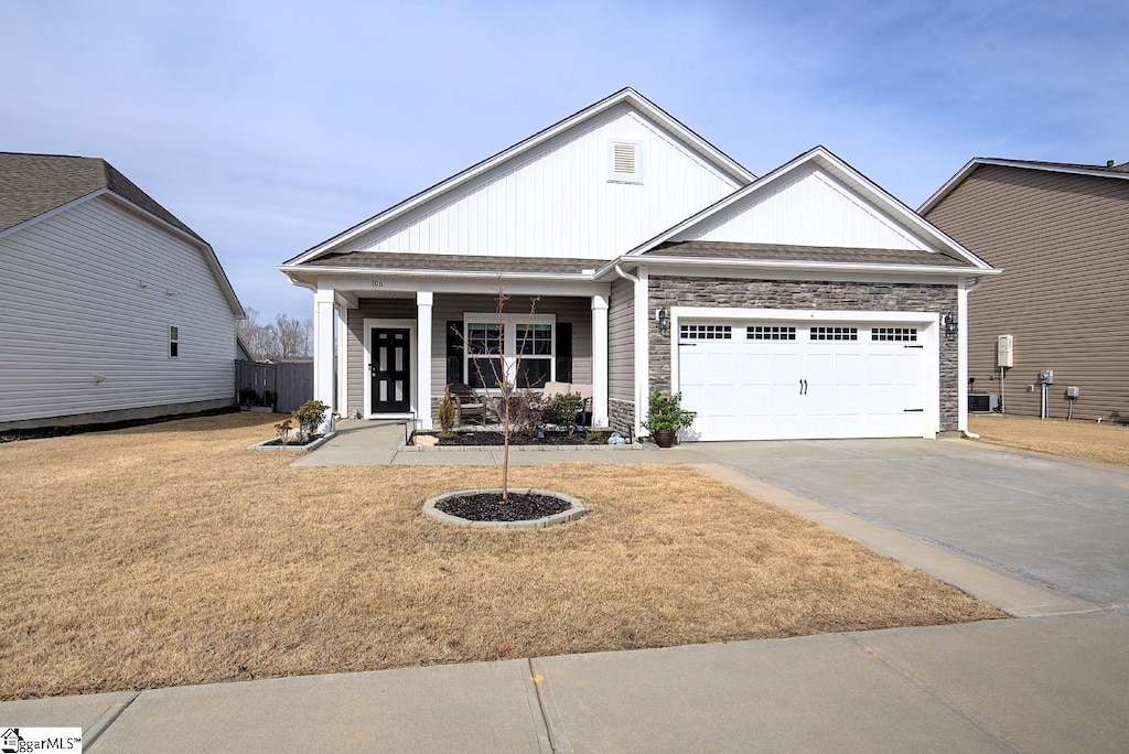 view of front of property with a garage and a front lawn