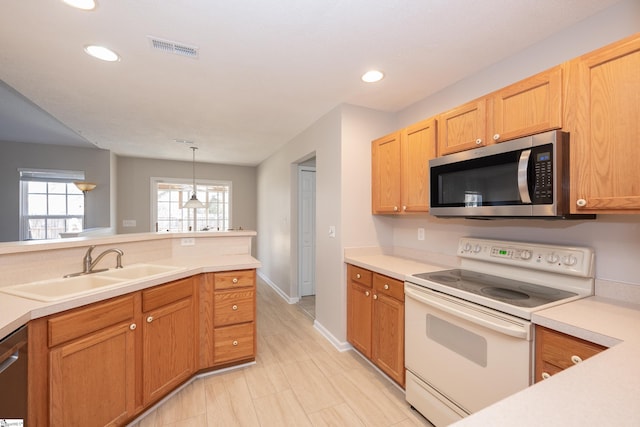 kitchen with sink, stainless steel appliances, and hanging light fixtures