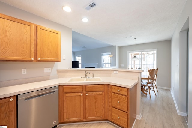 kitchen with pendant lighting, sink, kitchen peninsula, and dishwasher