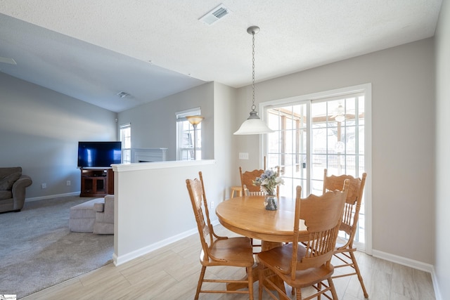 dining space with a textured ceiling