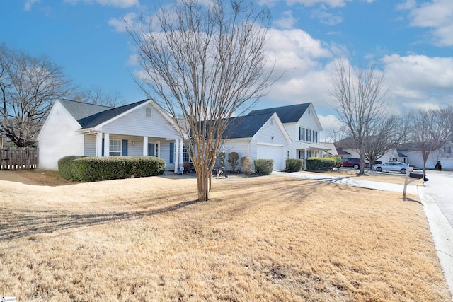 view of front of property with a garage and a front lawn