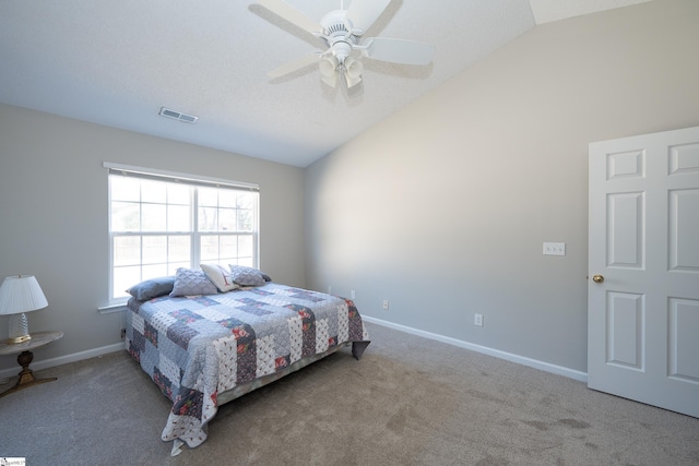 bedroom with ceiling fan, lofted ceiling, and carpet