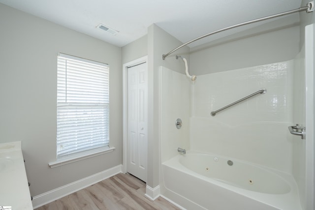 bathroom featuring bathing tub / shower combination, wood-type flooring, and vanity