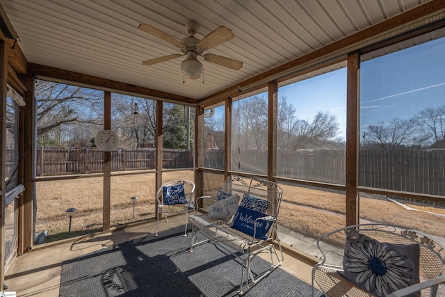 unfurnished sunroom featuring ceiling fan