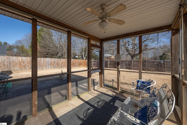 sunroom / solarium featuring ceiling fan