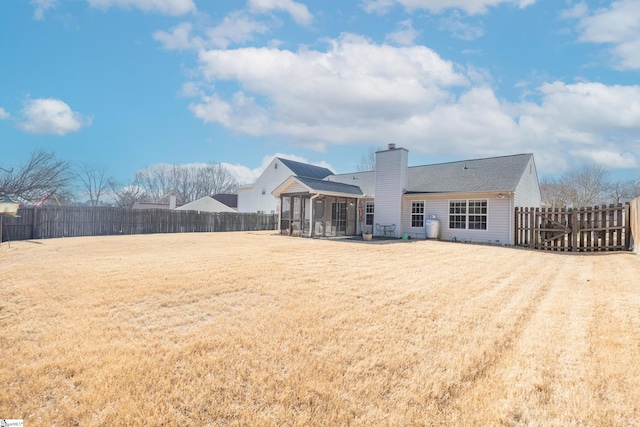 back of property featuring a yard and a sunroom