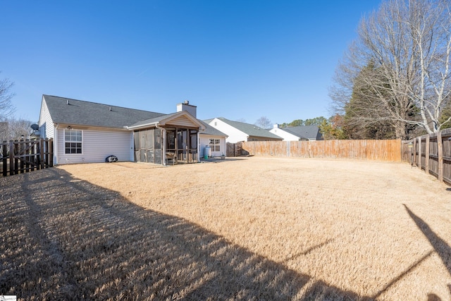 back of property with a sunroom