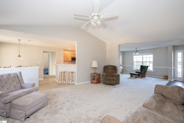 living room featuring ceiling fan, lofted ceiling, and light carpet