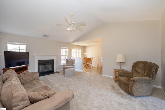 carpeted living room featuring ceiling fan and lofted ceiling