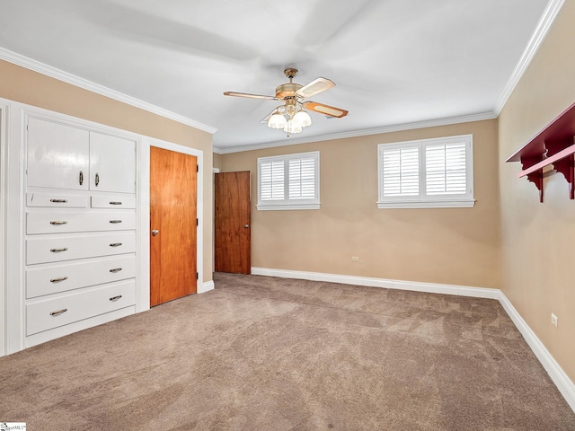 unfurnished bedroom with crown molding, carpet floors, and ceiling fan