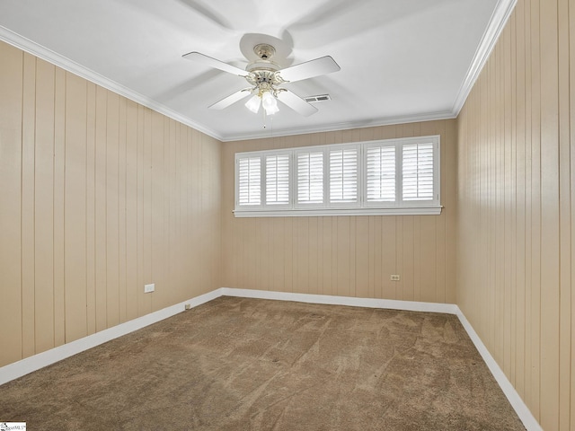 carpeted empty room with crown molding and ceiling fan