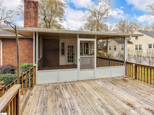 wooden deck featuring a sunroom