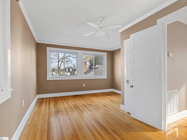 unfurnished room featuring ornamental molding, a textured ceiling, ceiling fan, and light wood-type flooring