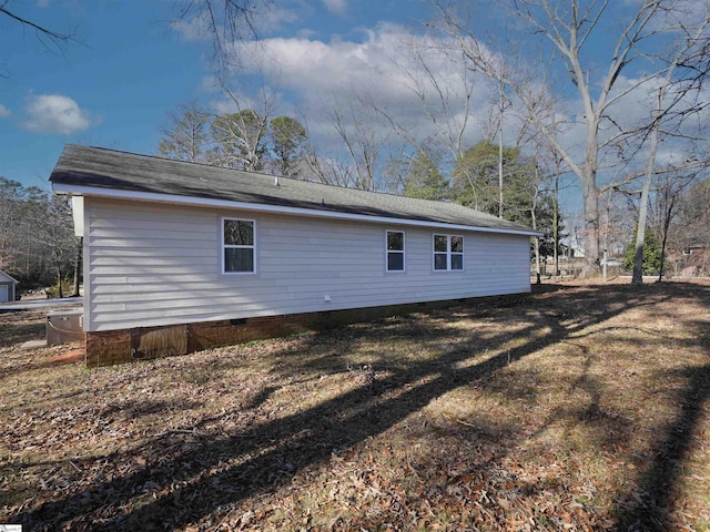 view of side of home featuring a lawn