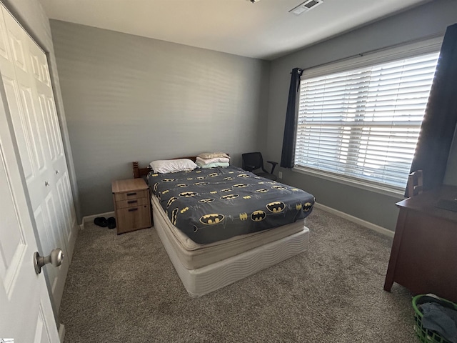 bedroom with a closet and carpet