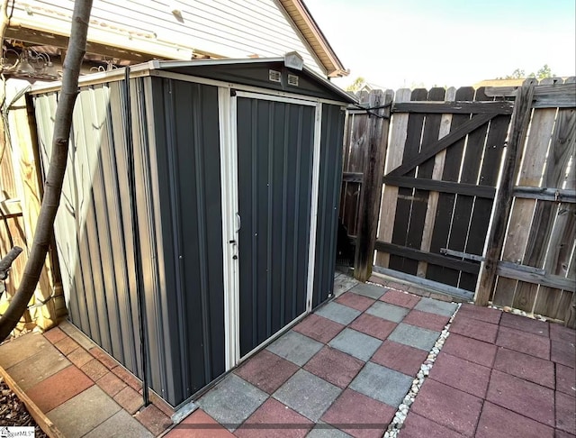 view of patio with a storage shed