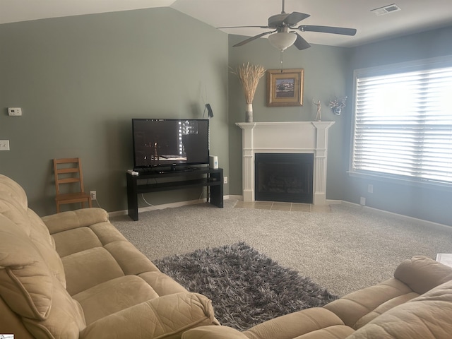 living room featuring ceiling fan, vaulted ceiling, and carpet