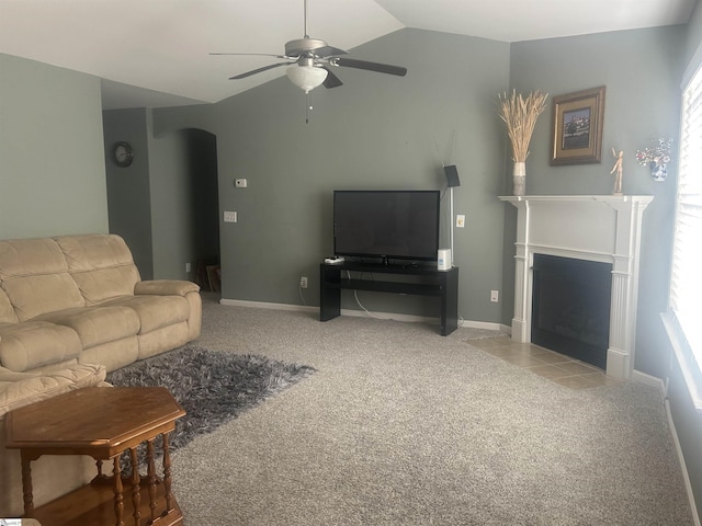 carpeted living room featuring vaulted ceiling and ceiling fan