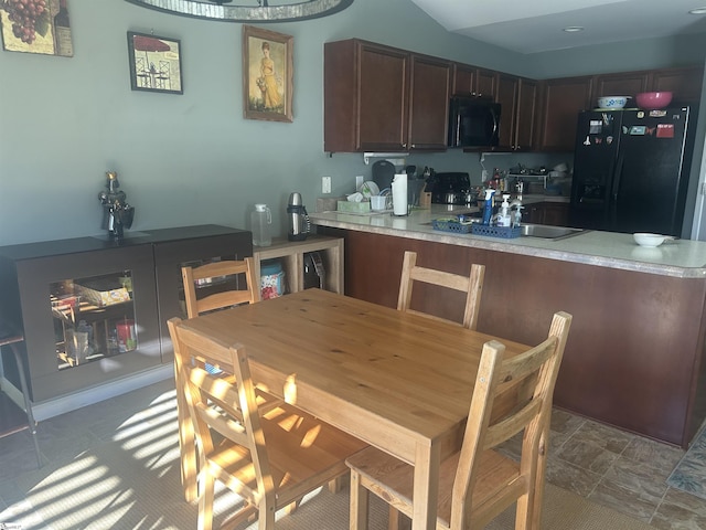 kitchen featuring black appliances and kitchen peninsula