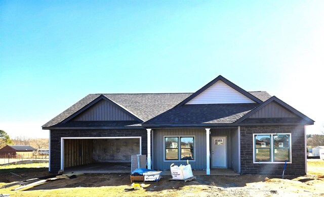 136 Jonah Rd, Gaffney, SC 29341 - view of front facade featuring stone siding, board and batten siding, a garage, and roof with shingles